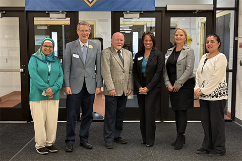 A group photo of Interim Provost Dr. Kevin Corcoran and School of Education and Human Services Dean Dr. Jon Margerum-Leys and others at Universal Academy